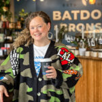 Krista Bentow, owner of Batdorf & Bronson Legacy Cafe in downtown Olympia, holding a coffee inside the cafe