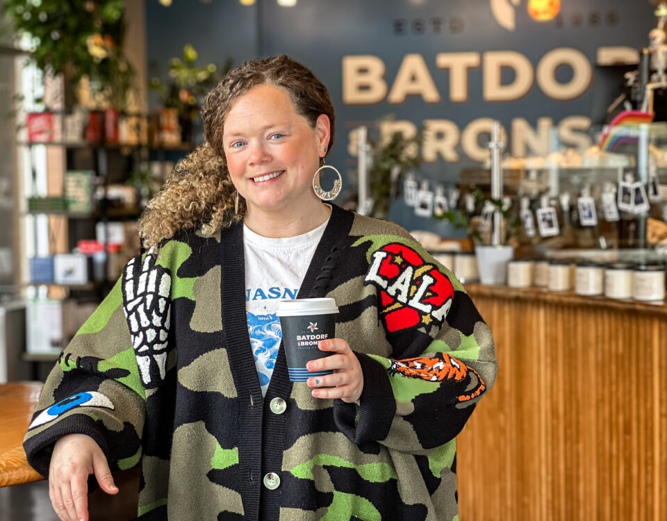 Krista Bentow, owner of Batdorf & Bronson Legacy Cafe in downtown Olympia, holding a coffee inside the cafe